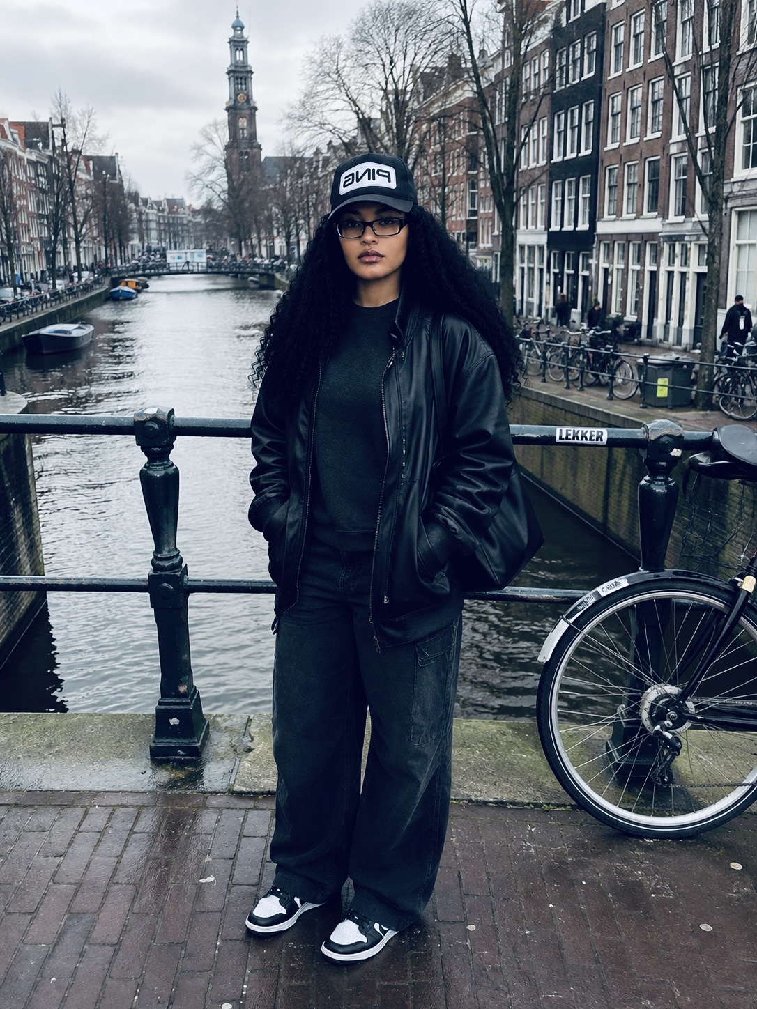 Full body photo of me in a black leather jacket standing beside an Amsterdam canal